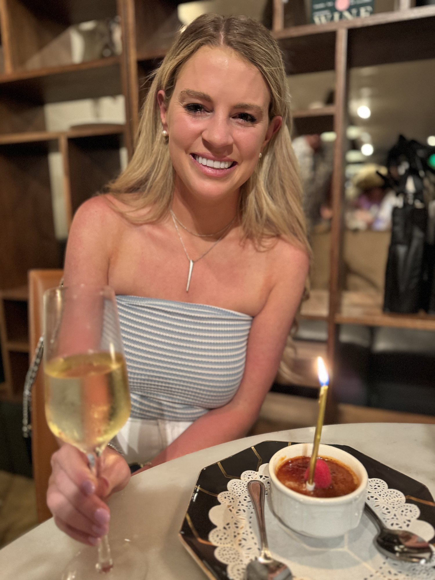 Savannah Sikes with a glass of bubbles and dessert at Vaudeville in Fredericksburg
